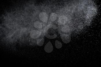 Water is sprayed randomly on a black background.