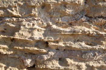 Texture background of sandstone in sunlight