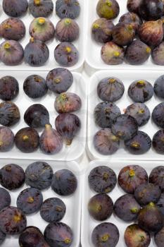 Background from fresh ripe figs on a white substrate