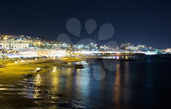 Night view of the beach of Playa Torviscas, Costa Adeje, Tenerife and the sea.