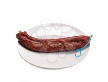 Spanish Fouette turkey sausage on a plate. Isolate on white background.