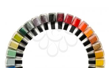 Bottles with nail polish arranged in a semicircle. Isolate on white.