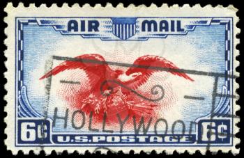 Royalty Free Photo of a 1938 US Stamp With an Eagle Holding Shield, Olive Branch and Arrows