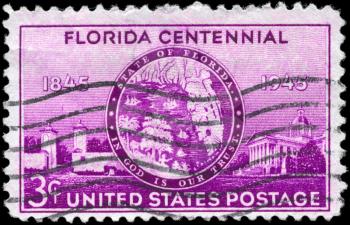 Royalty Free Photo of a 1945 US Stamp of an Old Florida Seal, St. Augustine Gates and State Capitol, Florida Statehood Centenary