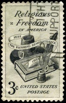 Royalty Free Photo of 1957 US Stamp Shows the Bible, Hat and Quill Pen, Religious Freedom Issue
