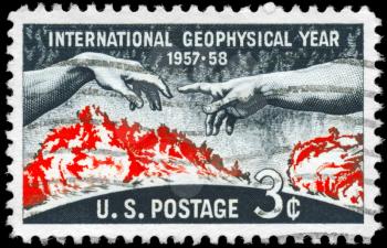 Royalty Free Photo of 1958 US Stamp Shows the Solar Disc and Hands from Michelangelos Creation of Adam Geophysical Year