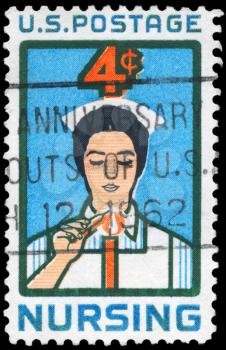 Royalty Free Photo of 1961 US Stamps Shows a Student Nurse lighting Candle, Nursing Issue