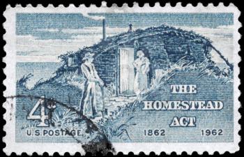 Royalty Free Photo of 1962 US Stamp Shows the Sod Hut and Settlers, Homestead Act Centenary