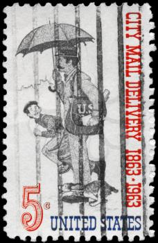 Royalty Free Photo of 1963 US Stamp Shows the Letter Carrier, Free City Mail Delivery Centenary