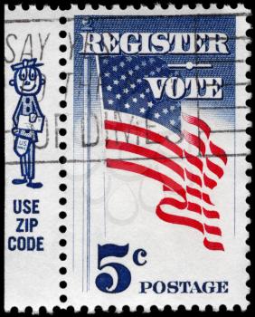 Royalty Free Photo of 1964 US Stamp Shows the U.S. Flag, Inscribed Register Vote and a Cartoon Mailman