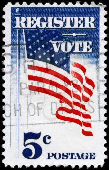 Royalty Free Photo of 1964 US Stamp Shows the U.S. Flag, With the Inscription Register Vote
