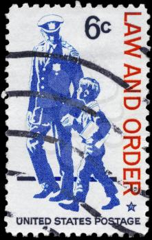 Royalty Free Photo of 1968 US Stamp Shows Policeman and Small Boy, Law and Order Issue