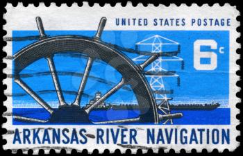 Royalty Free Photo of 1968 US Stamp Shows the Ships Wheel, Power Transmission Tower and Barge, Arkansas River Navigation