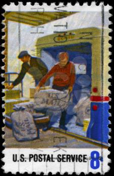 Royalty Free Photo of 1973 US Stamp Shows the Loading Mail on Truck, Postal Service Employees