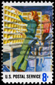 Royalty Free Photo of US 1973 Stamp Shows the Manual Letter Routing, Postal Service Employees