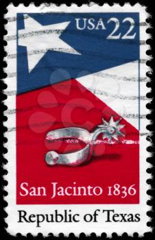 Royalty Free Photo of 1986 US Stamp Shows the Texas State Flag and Silver Spur, 150th Anniversary