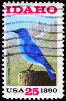 Royalty Free Photo of 1990 US Stamp Shows the Mountain Bluebird, Sawtooth Mountains, Idaho State Centenary