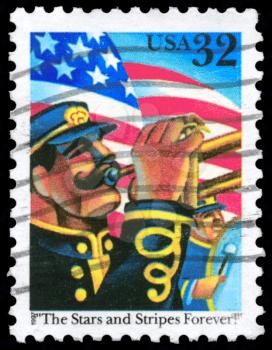 Royalty Free Photo of 1997 US Stamp Shows the US Flag and Trumpeter, Inscribed With The Stars and Stripes Forever