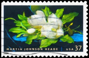 Royalty Free Photo of 2004 US Stamp Shows the Giant Magnolias on a Blue Velvet Cloth, by Martin Johnson Heade (1819-1904)