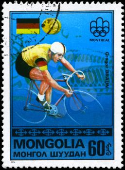 MONGOLIA - CIRCA 1976: A Stamp printed in MONGOLIA shows the Gregor Braun, Montreal Games Emblem, German Flag, Gold Medals from the series Gold medal winners, 21st Olympic Games, Montreal, Canada, 