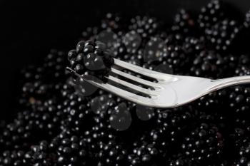 Royalty Free Photo of a Blackberry on a Fork