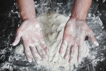 Royalty Free Photo of a Person With Hands Full of Flour