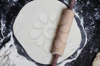 Royalty Free Photo of a Rolling Pin on Dough
