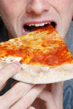 Royalty Free Photo of a Person Eating Pizza