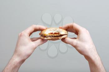 Royalty Free Photo of a Person Eating a Hamburger