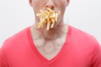 Royalty Free Photo of a Man With a Mouthful of French Fries