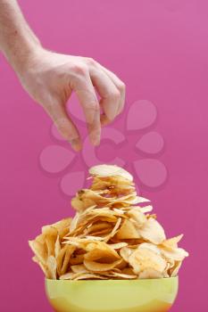 Royalty Free Photo of a Person Eating Potato Chips