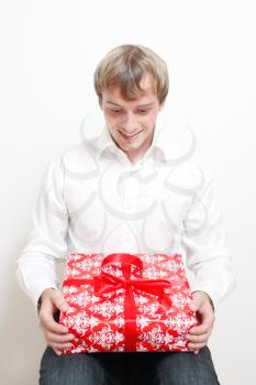 Royalty Free Photo of a Man Holding a Christmas Present