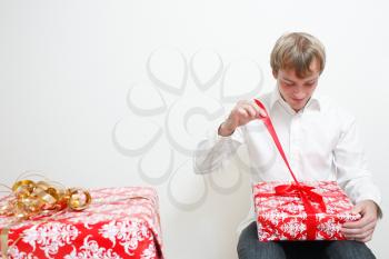 Royalty Free Photo of a Man Opening a Present