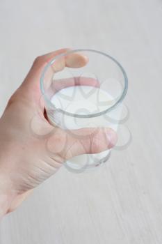 Royalty Free Photo of a Person Holding a Glass of Milk