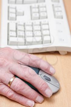 Royalty Free Photo of an Elderly Person Using a Computer