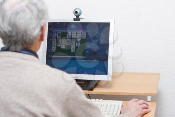Royalty Free Photo of an Elderly Man Using a Computer