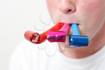 Royalty Free Photo of a Person Playing With Party Blowers