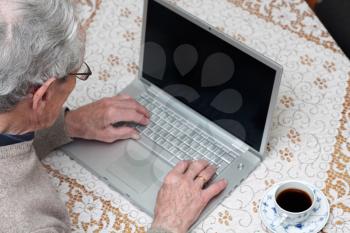 Royalty Free Photo of an Elderly Man Using a Laptop