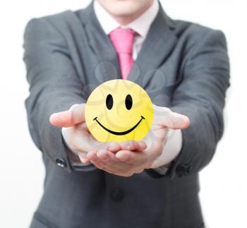 Royalty Free Photo of a Businessman Holding a Smiley Face