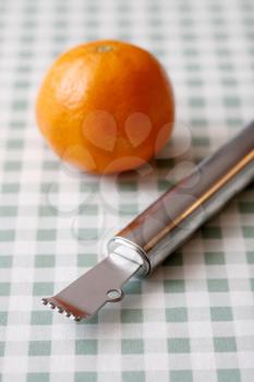 Royalty Free Photo of a Clementine and Peeler