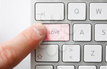 Royalty Free Photo of a Person Pushing a Love Button on a Keyboard