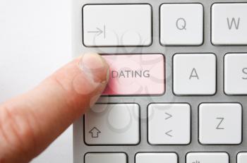 Royalty Free Photo of a Man Pressing a Dating Button on a Keyboard
