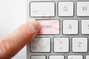 Royalty Free Photo of a Man Pushing a Pornography Button
