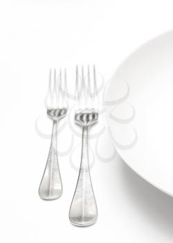 Royalty Free Photo of Forks Beside a Plate