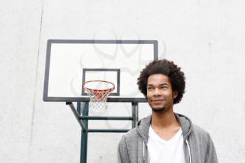 Royalty Free Photo of a Man by a Basketball Net