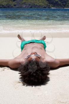 Royalty Free Photo of a Man Sleeping at the Beach