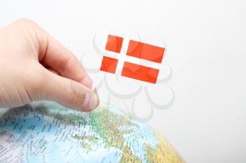 Royalty Free Photo of a Person Marking Denmark on a Globe