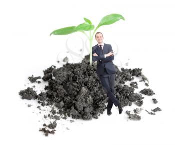 Royalty Free Photo of a Businessman by a Plant