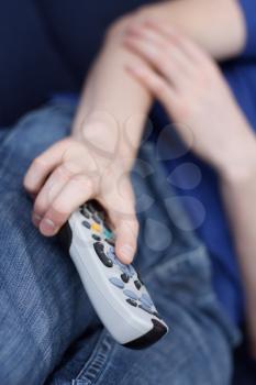 Royalty Free Photo of a Guy Watching TV Holding a Remote