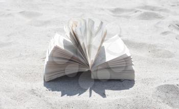 Royalty Free Photo of a Book on the Beach